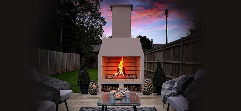 Schiedel outdoor fireplace with a large chimney stack and a lit fire, Nulty Providers Drogheda