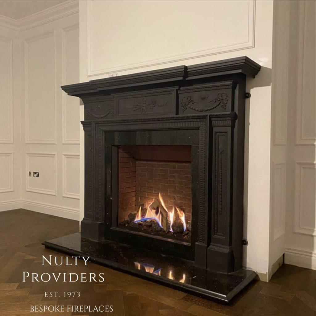 Black Galaxy granite hearth with custom profiled edge under a Gazco 75th gas fire in an antique cast iron fireplace, Co. Meath